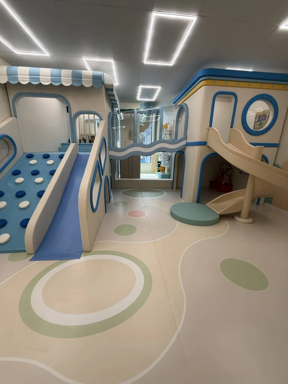 The indoor play area with slides and a climbing wall