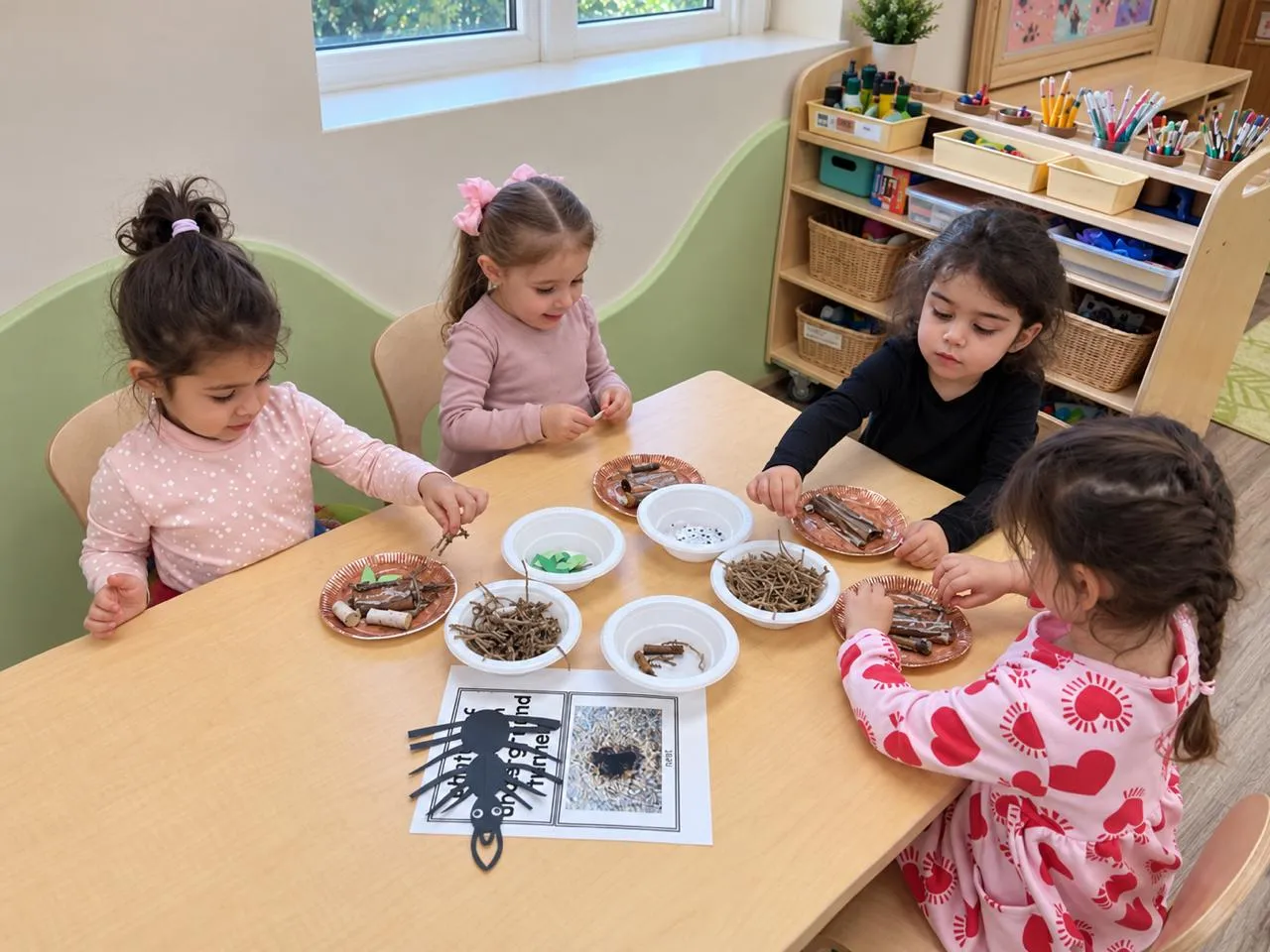 Preschoolers sorting leaves, seeds and shells at a table