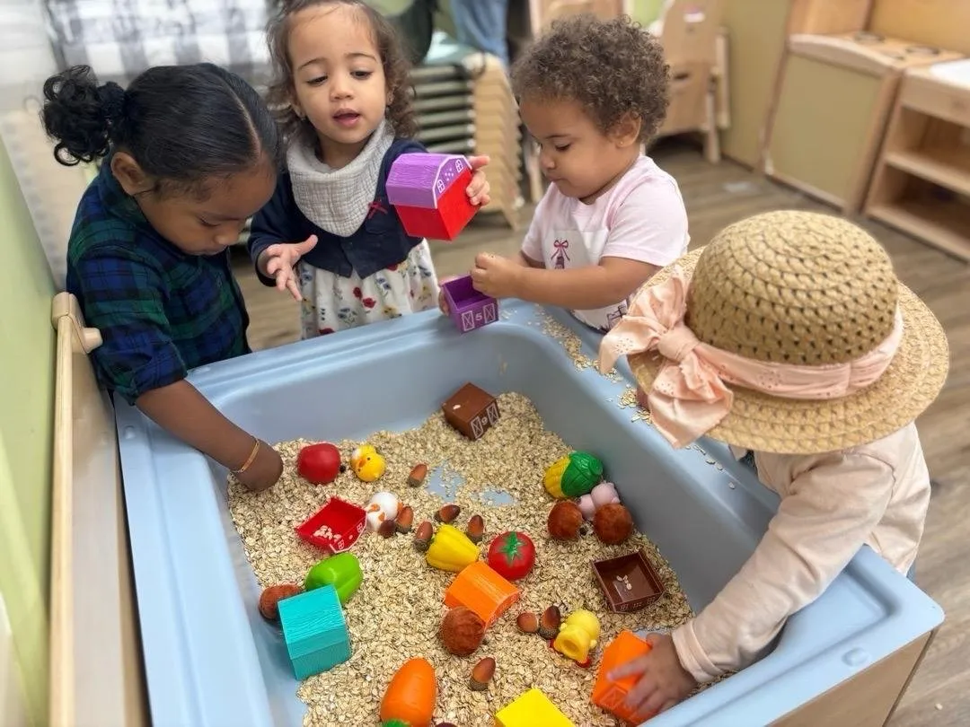 Toddlers exploring a sensory table